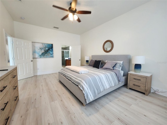 bedroom featuring ensuite bath, light hardwood / wood-style flooring, and ceiling fan