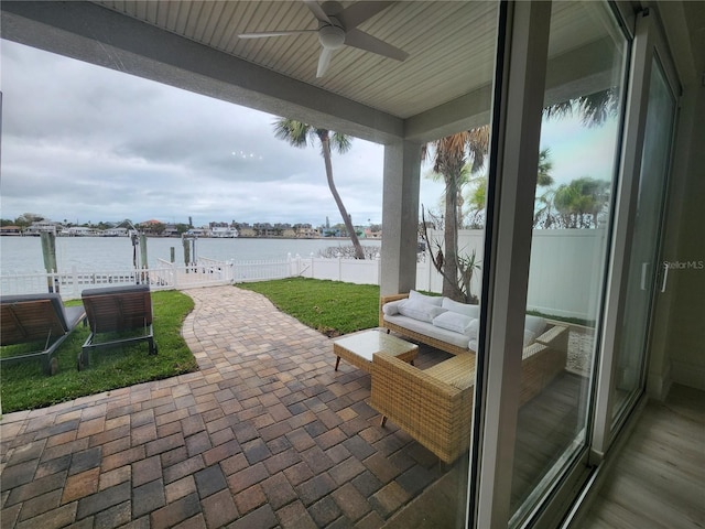 view of patio / terrace with a water view, outdoor lounge area, and ceiling fan