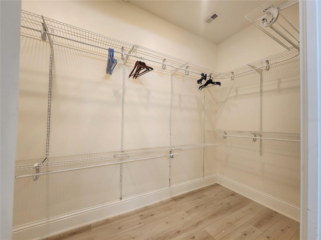 spacious closet featuring hardwood / wood-style floors