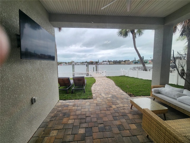 view of patio featuring outdoor lounge area, ceiling fan, and a water view