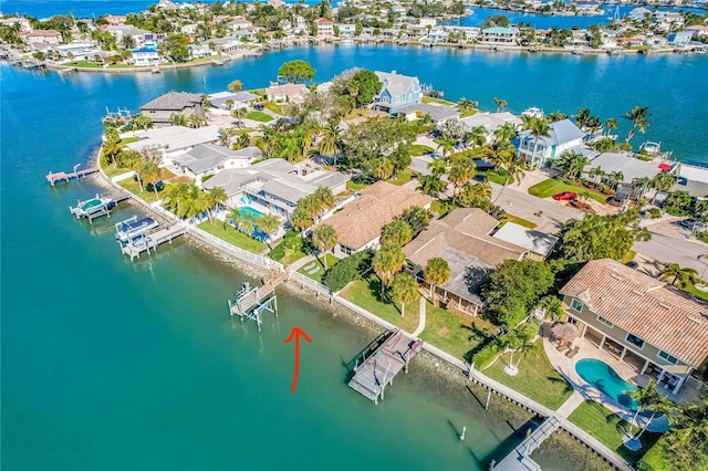 birds eye view of property with a water view and a residential view