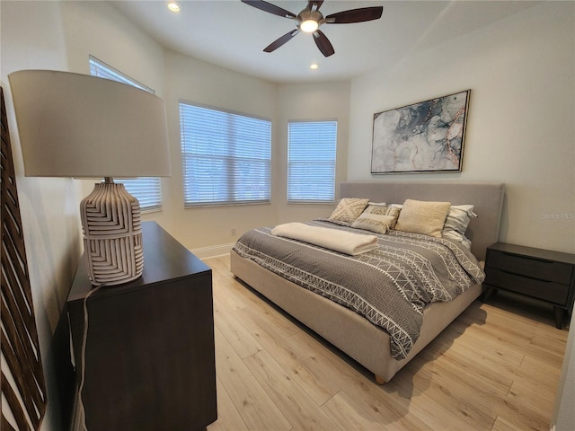 bedroom featuring a ceiling fan, recessed lighting, multiple windows, and light wood-style flooring