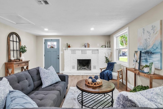 living room featuring hardwood / wood-style flooring and a fireplace