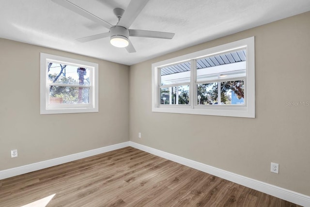 spare room with ceiling fan and light wood-type flooring