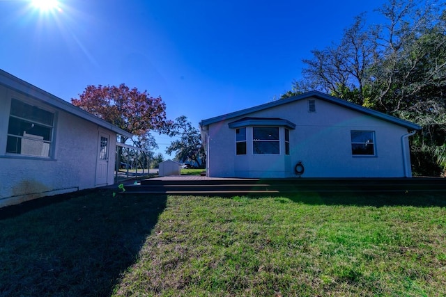 rear view of house featuring a lawn