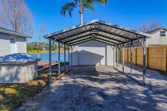 view of parking with a carport and a water view