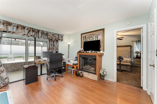 office with hardwood / wood-style flooring and a textured ceiling