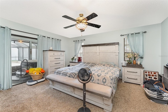 carpeted bedroom with a textured ceiling and ceiling fan