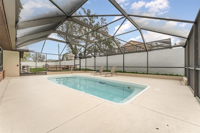 view of swimming pool with a lanai and a patio area