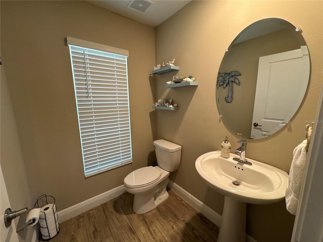 bathroom featuring hardwood / wood-style flooring, sink, and toilet