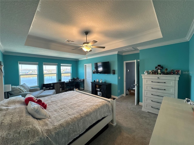 carpeted bedroom featuring ornamental molding, a raised ceiling, ceiling fan, and a water view