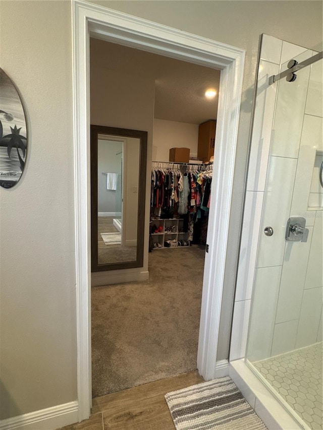 bathroom featuring walk in shower and hardwood / wood-style flooring