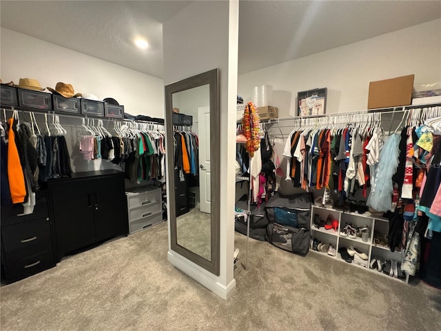 walk in closet featuring light carpet