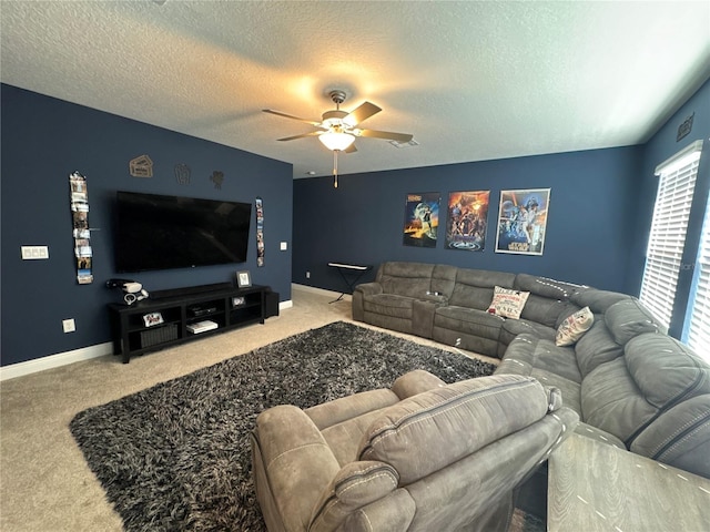 living room featuring a textured ceiling, carpet floors, and ceiling fan