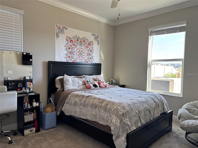 bedroom with crown molding, ceiling fan, and carpet flooring