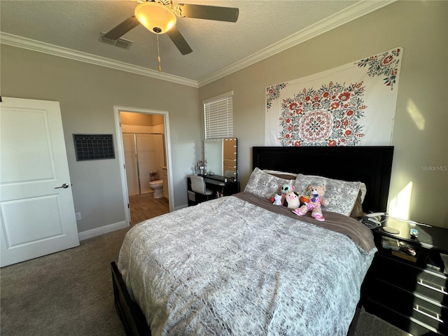 bedroom featuring crown molding, dark carpet, ensuite bath, and ceiling fan