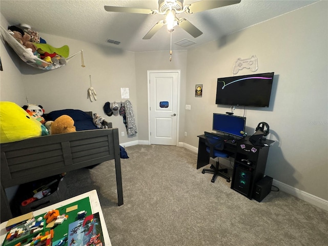 carpeted bedroom with a textured ceiling and ceiling fan