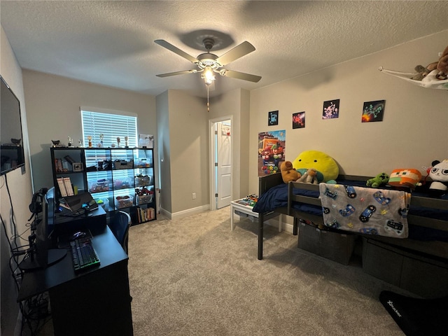 carpeted bedroom featuring a textured ceiling and ceiling fan