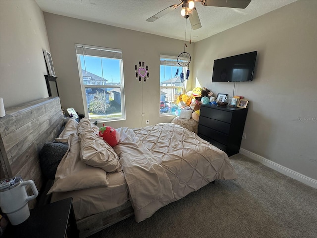 bedroom with carpet flooring, a textured ceiling, and ceiling fan