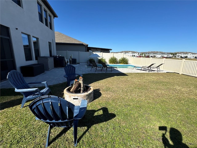 view of yard featuring a fenced in pool, a patio, central air condition unit, and an outdoor fire pit