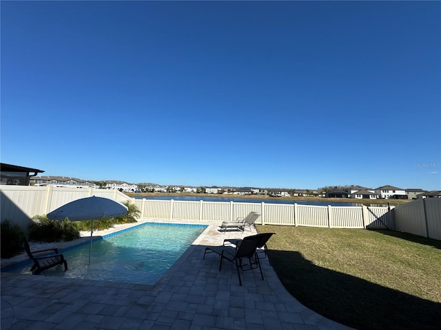 view of swimming pool with a yard and a patio