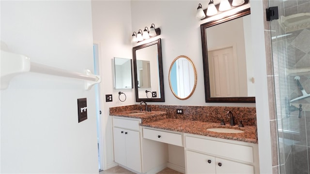 bathroom with vanity and a shower with door