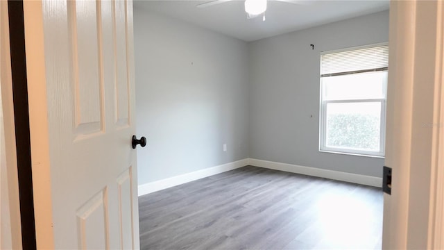 unfurnished room featuring hardwood / wood-style floors and ceiling fan