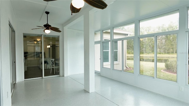 unfurnished sunroom featuring ceiling fan