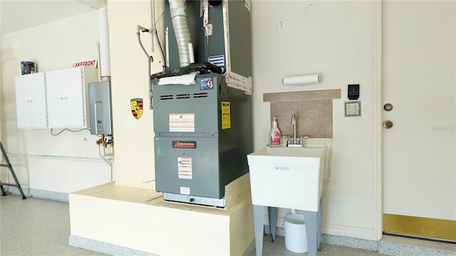 utility room featuring water heater and heating unit