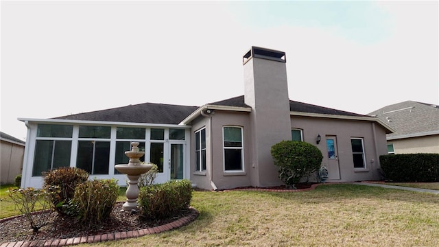 rear view of property featuring a yard