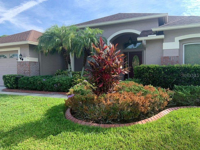 view of front of property with a garage and a front lawn