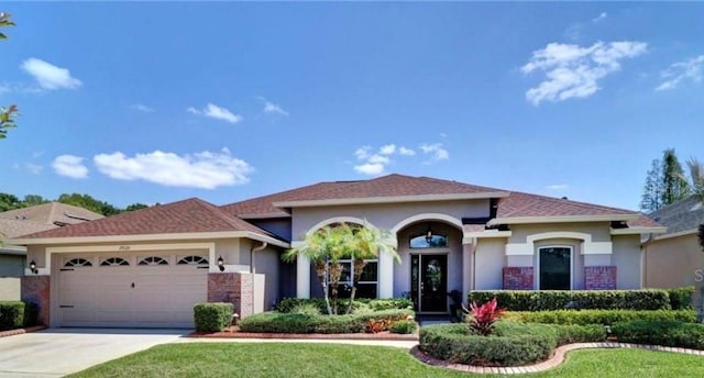 view of front of property featuring a garage and a front lawn