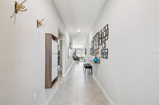 hallway featuring light tile patterned floors