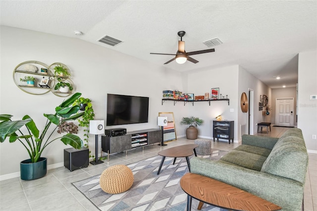 tiled living room featuring ceiling fan and a textured ceiling