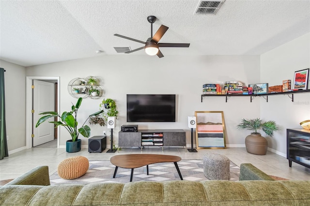 tiled living room with lofted ceiling, a textured ceiling, and ceiling fan