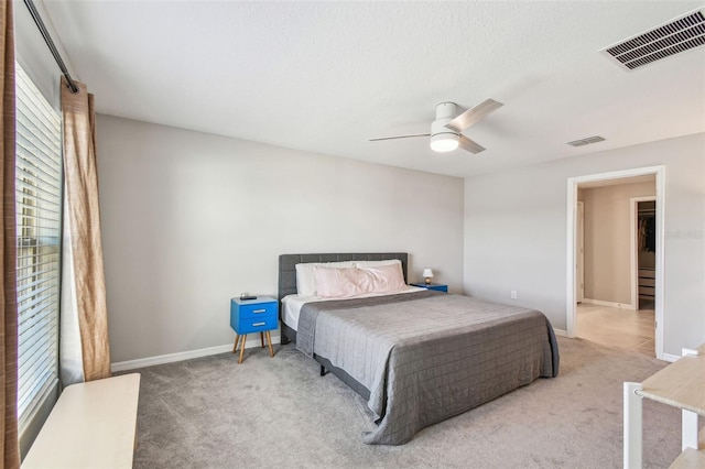 bedroom featuring ceiling fan and light colored carpet