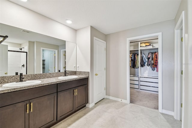 bathroom with vanity, tile patterned floors, and a shower with shower door