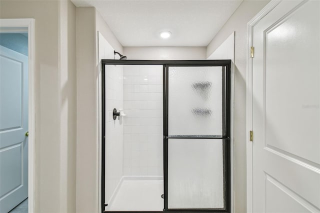 bathroom featuring a shower with door