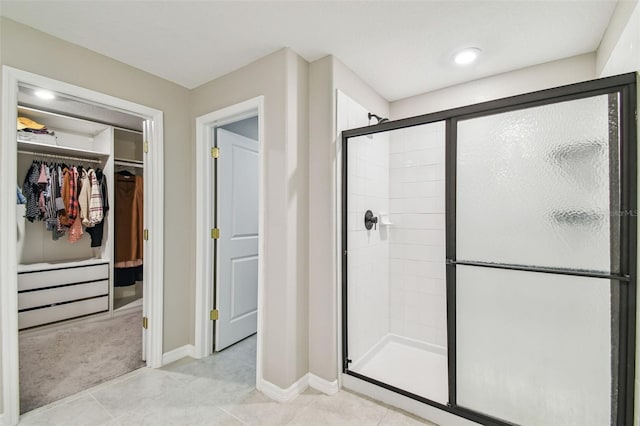 bathroom with tile patterned floors and a shower with shower door