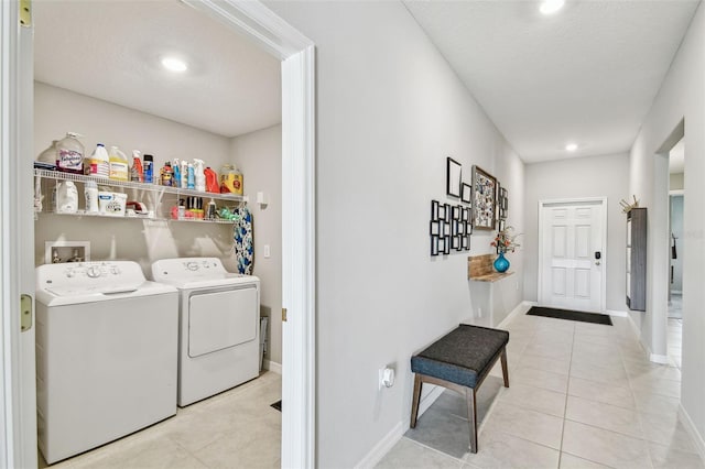 washroom with light tile patterned flooring and washer and dryer