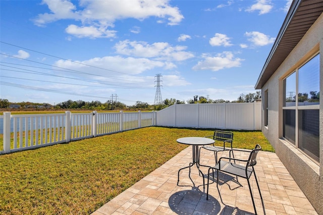 view of yard with a water view and a patio