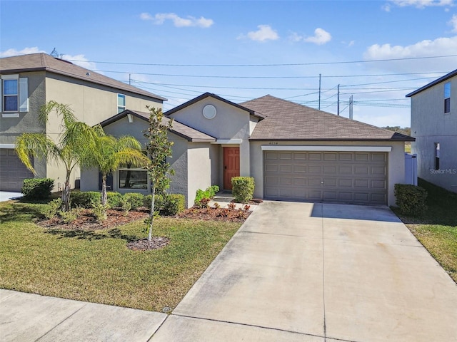 view of front of home with a garage and a front lawn