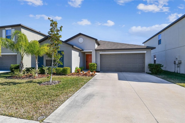 view of front of property featuring a garage and a front yard