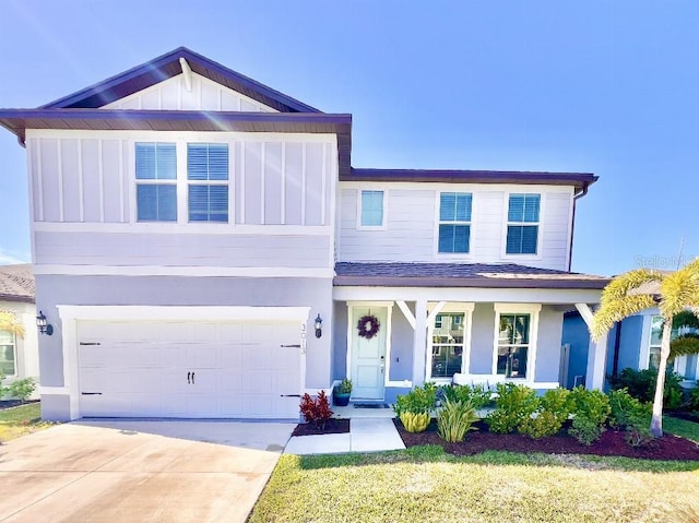 view of front of home with a porch, a garage, and a front lawn