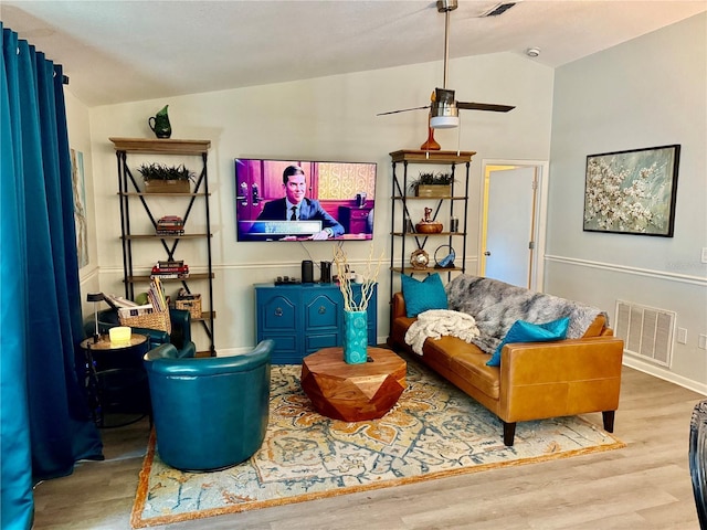 living area featuring vaulted ceiling and light wood-type flooring