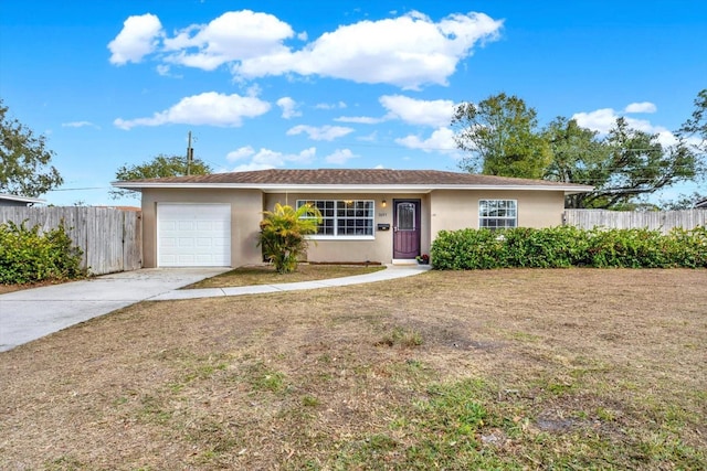 ranch-style home with a garage and a front yard