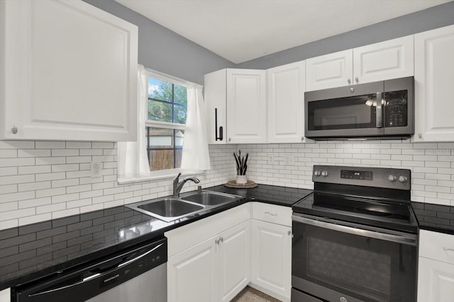 kitchen featuring backsplash, stainless steel appliances, sink, and white cabinets