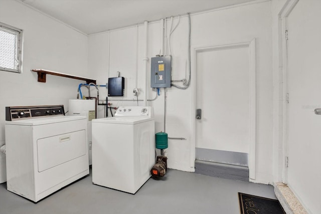 clothes washing area with electric panel, washer and clothes dryer, and water heater