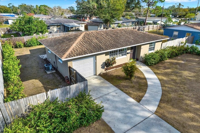 ranch-style house featuring a garage and central AC