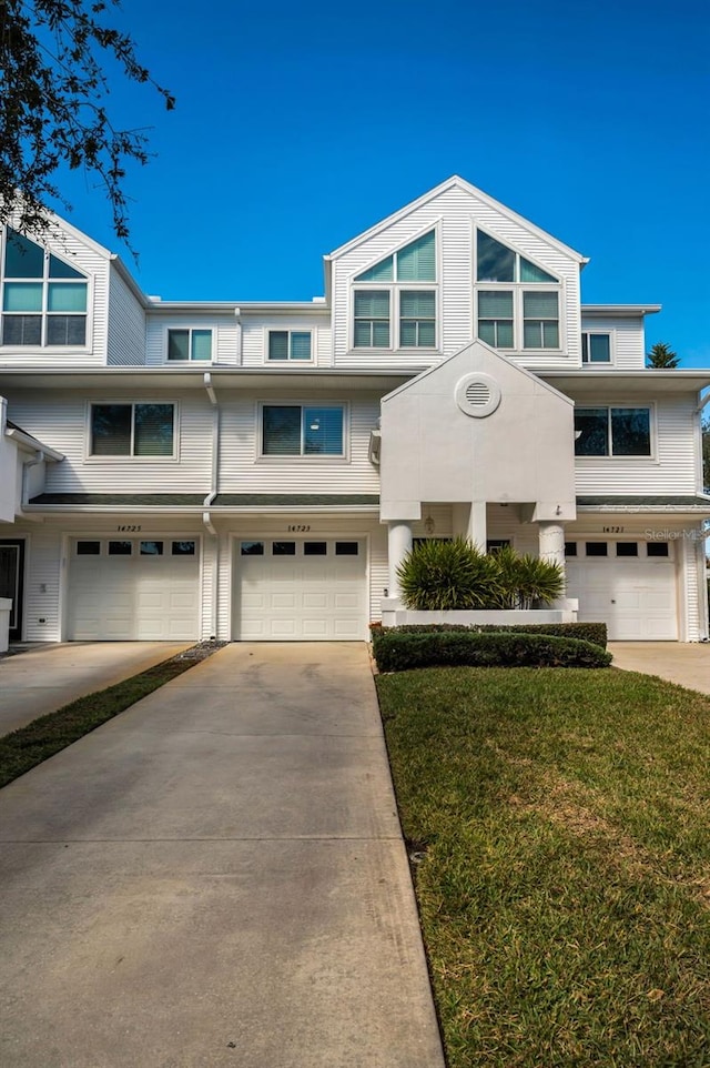 view of front of house with a garage and a front yard